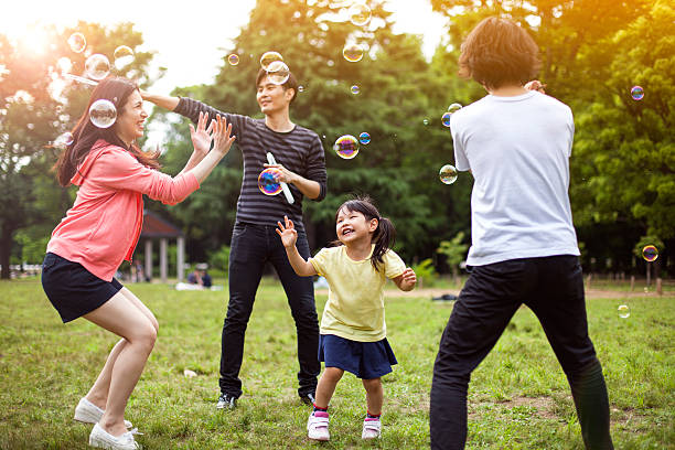 istock Family having fun in park with Soap Bubbles 514259356