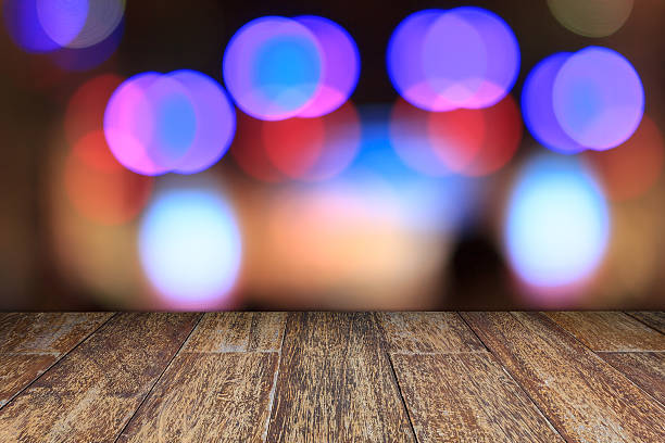 istock Empty old wooden floor and blurred abstract circular city night 514260214
