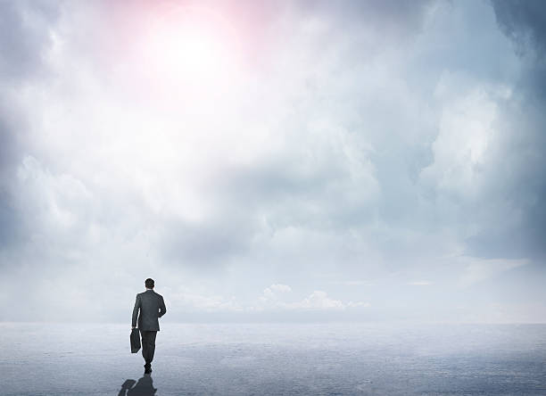 istock Businessman  Walking Toward The Horizon In A Remote Scene 514260966