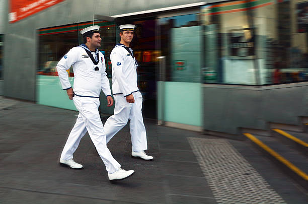 Royal Australian Navy sailors Melbourne, Australia - April 13, 2014: Royal Australian Navy sailors walk in Federation Square. The Royal Australian Navy (RAN) consists of 51 commissioned vessels and over 16,000 personnel. australian navy stock pictures, royalty-free photos & images