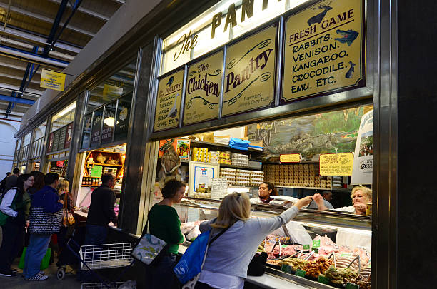 Melbourne, Australia - April 12, 2014: Shoppers buy fresh produce at Queen Victoria Market. It is a major landmark and the largest open air market in the Southern Hemisphere.