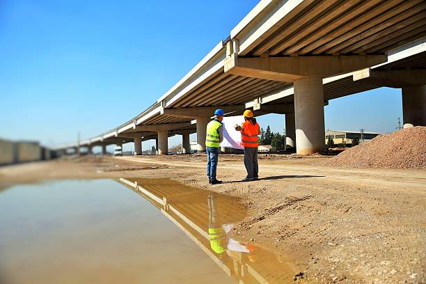 Highway engineer Two construction workers or engineers. bridge built structure stock pictures, royalty-free photos & images