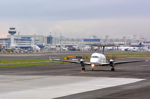 Auckland, New Zealand - April 10, 2014: Jet aircraft on the runway of Auckland International Airport. It's the largest and busiest airport in New Zealand with 14,006,122 passengers in 2011