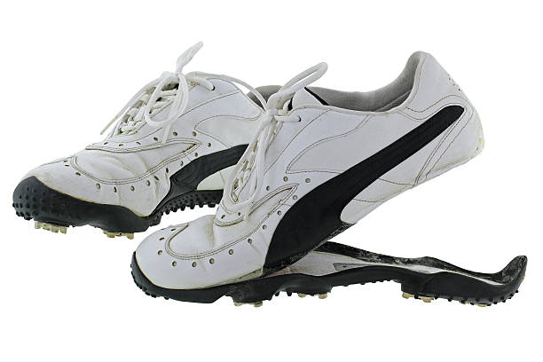 Old and dirty Golf shoes with split rubber sole stock photo