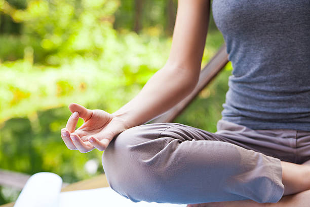 istock Young girl doing yoga lotus pose in park 514268343