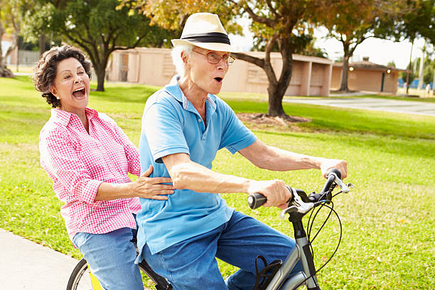 istock Senior Hispanic Couple Riding Bikes In Park 514269617