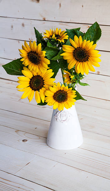 istock Sunflowers in a vase on rustic, gray background 514269825