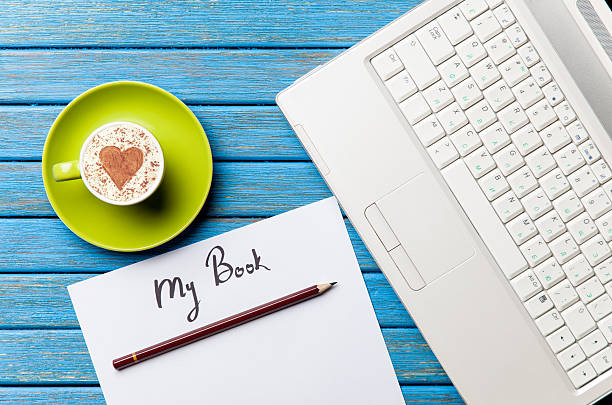 istock paper, coffee and laptop lying on the table 514269880