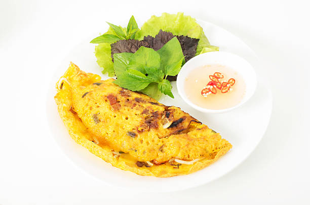 Banh Xeo, Vietnamese pancake with vegetables and fish sauce Banh Xeo, Vietnamese pancake with vegetables and fish sauce vietnamese culture stock pictures, royalty-free photos & images