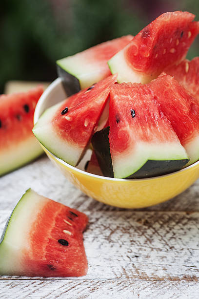 istock Watermelon pieces in a yellow plate on a table 514270745