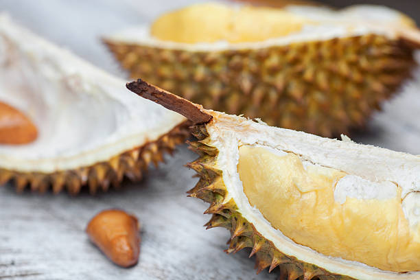 istock Durian cloves with yellow ripe pulp on table 514271361