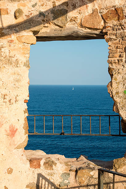 istock Padlocks in saracen tower over sea with sailing boat 514272381