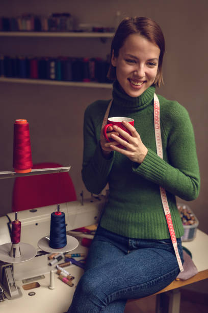 istock Smiling fashion designer having coffee break in her studio. 514273072