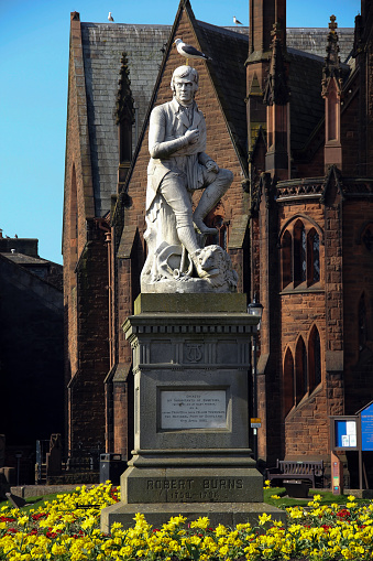 Statue of poet Robert Burns with seagull in Dumfries Scotland