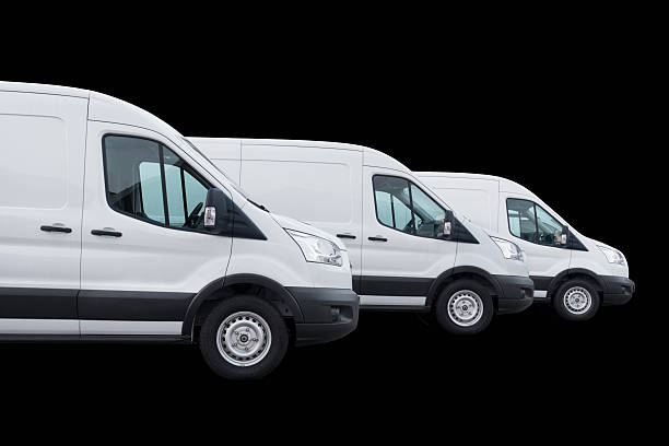 istock White delivery vans in a row on black 514273679