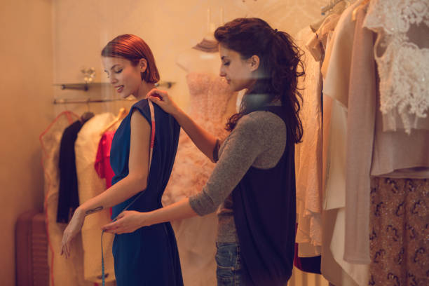 istock Tailor taking customers measurements in clothing store. 514273686