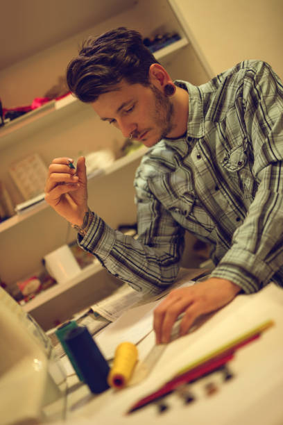 istock Serious fashion designer working on new ideas in studio. 514274004