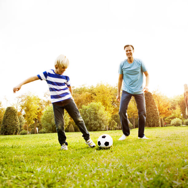 istock Father and son playing soccer 514274020