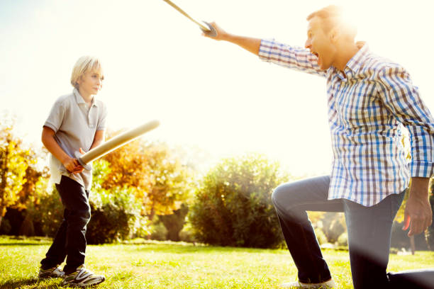 istock Father and son playing with swords 514274542