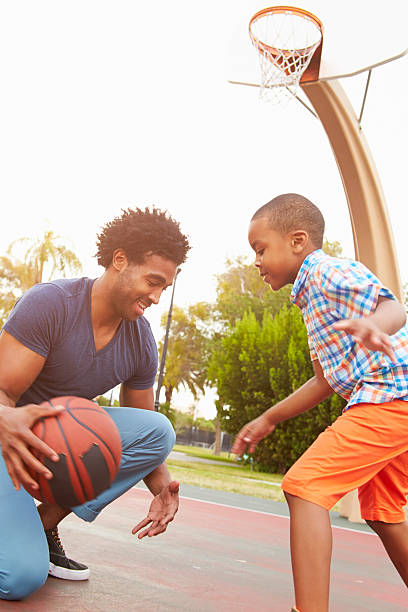 istock Father With Son Playing Basketball In Park Together 514274763