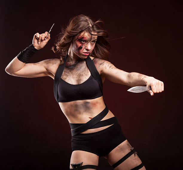 istock Killer woman with knife. Posing in studio. 514275086