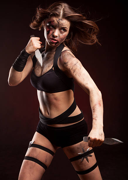 istock Killer woman with knife. Posing in studio. 514275112
