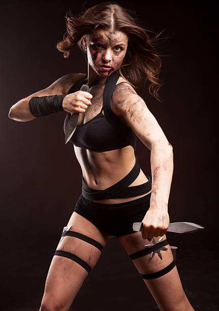 istock Killer woman with knife. Posing in studio. 514275114