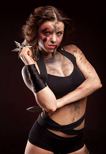 istock Killer woman with knife. Posing in studio. 514275132