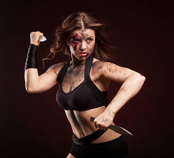 istock Killer woman with knife. Posing in studio. 514275136