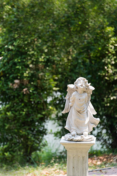 istock Angel statue in nature place in soft light 514275580