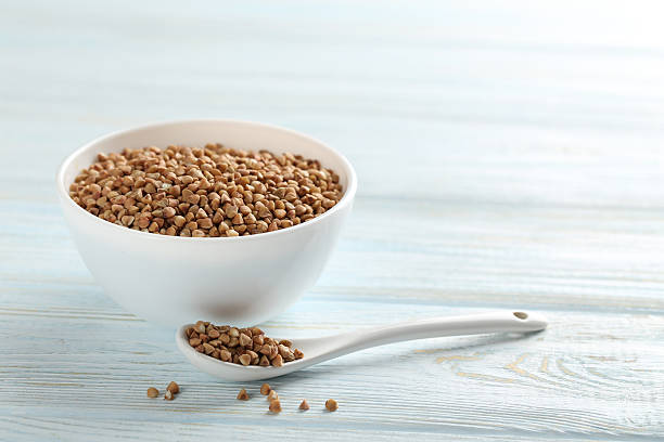 istock Buckwheat seeds in bowl on a blue wooden table 514278586