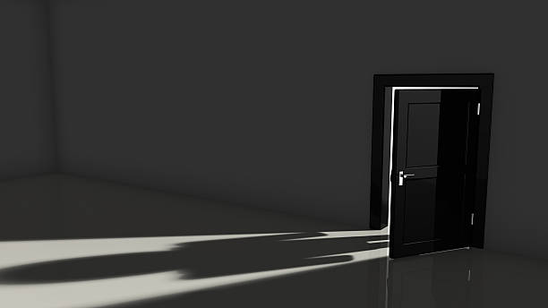 istock Black door opening in a dark room 514279492