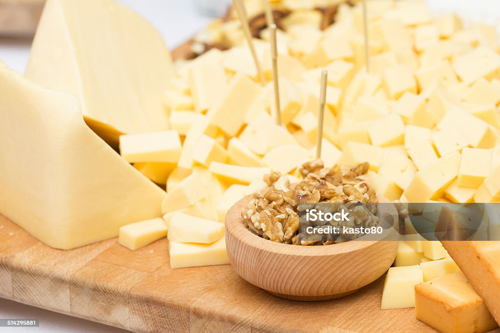 Cheese Plate with Dried Fruit and Honey Cheese Plate with Dried Fruit, Nuts and Honey. Rustic decoration on a wooden plate. Appetizer Stock Photo