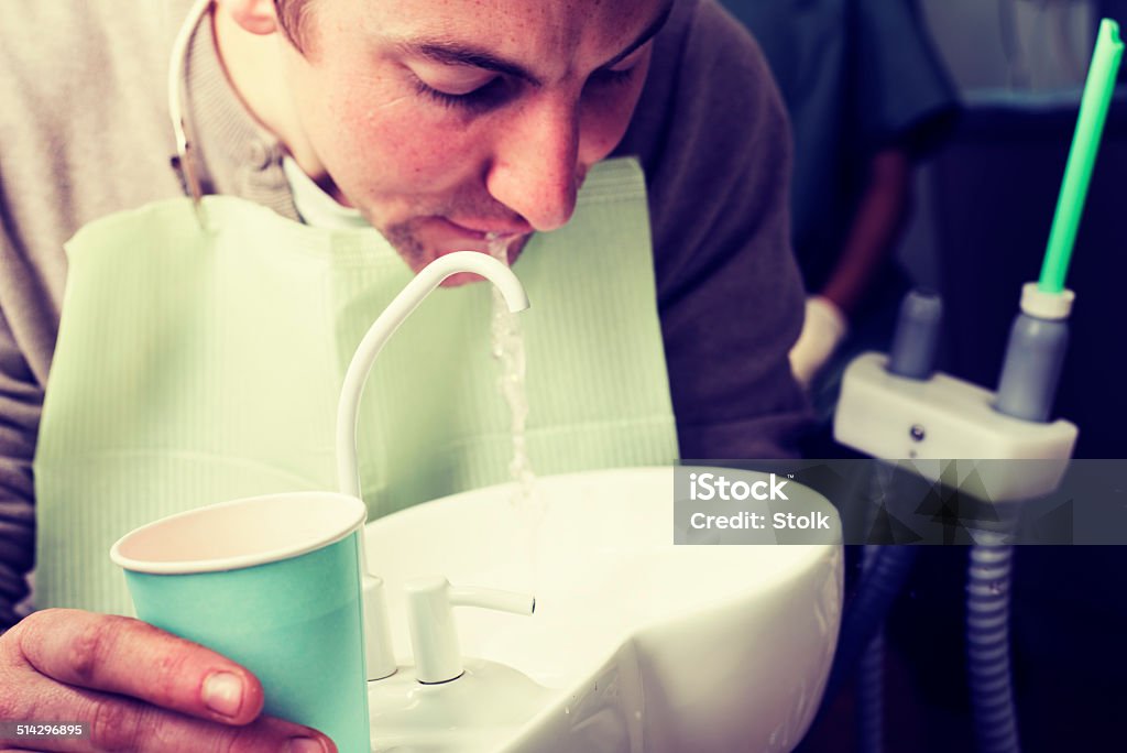 Spitting A male dentist patient Adult Stock Photo