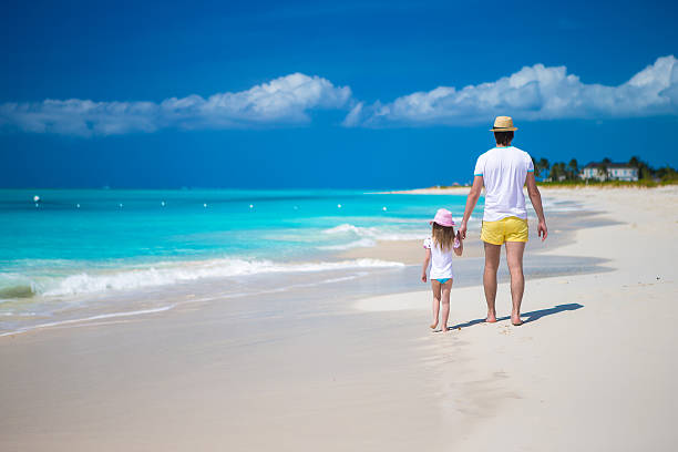 istock Happy father and his cute little daughter at beach 514299501