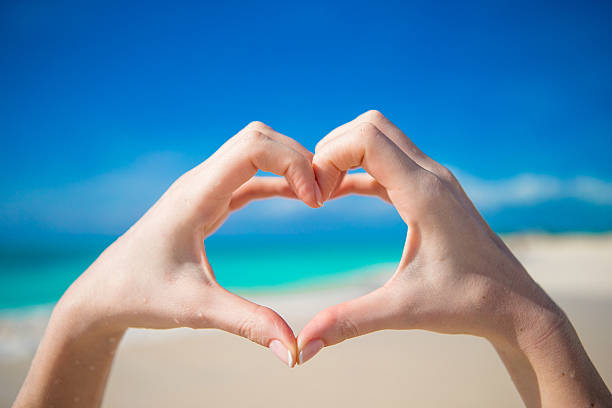 istock Heart made by hands background the turquoise ocean 514299769