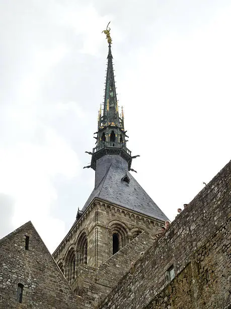 Photo of statue on spire of tower abbey mont saint-michel