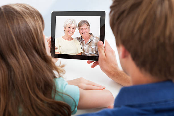 istock Daughter With Father Video Chatting On Digital Tablet 514300217
