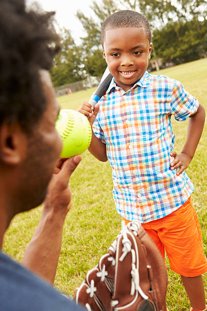 istock Father And Son Playing Baseball In Park 514300671