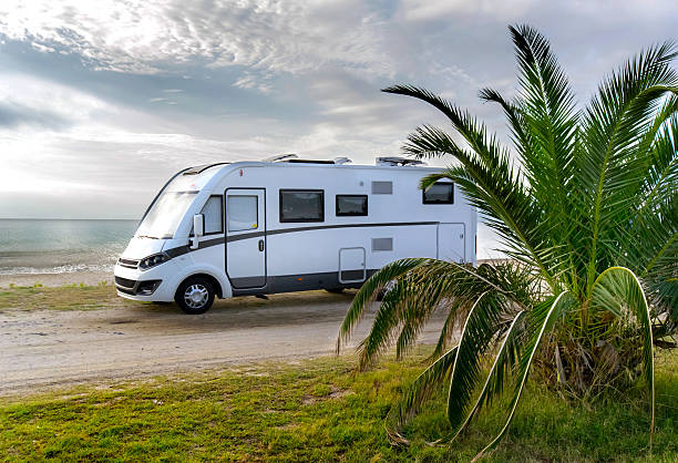 Camper van parked on a beach stock photo