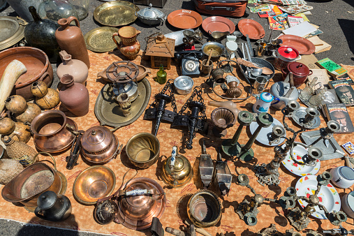 Lisbon, Portugal - August 19, 2014:  Objects used, furniture, artwork and ornaments on a market stall in the most famous flea market in Lisbon, also known as Feira Da Ladra, located in the district of Alfama.