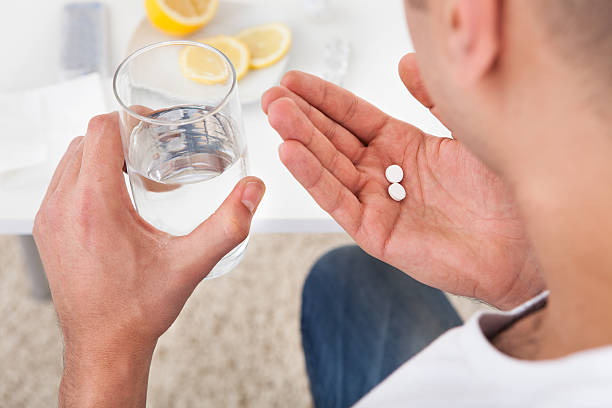 istock Sick Man Taking Tablets With Glass Of Water 514301513