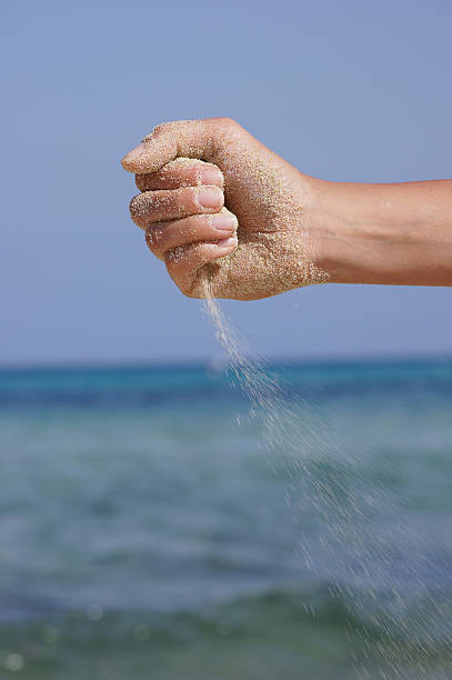 istock sand running through hands as a symbol for time running 514301999