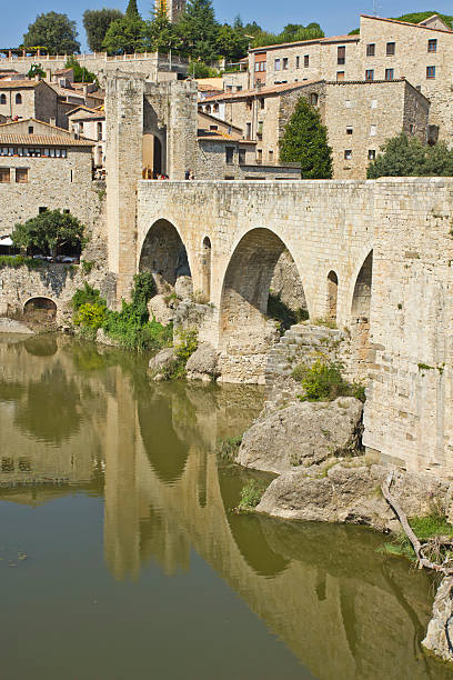 istock ancient roman bridge and town. 514302219
