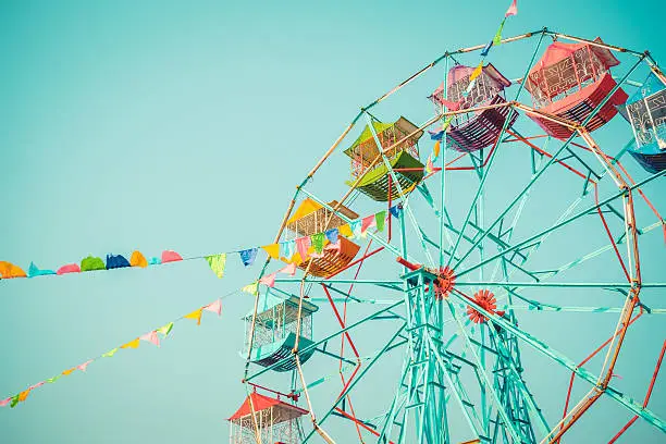 Photo of Ferris wheel on blue sky background vintage color