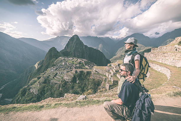istock Hugging couple looking at Machu Picchu, Peru, toned image 514309866