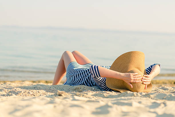 istock Woman with a straw hat laying at the seaside 514311214