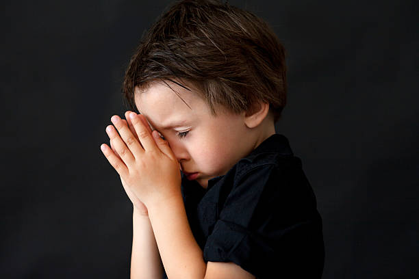 istock Little boy praying, child praying, isolated background 514312546