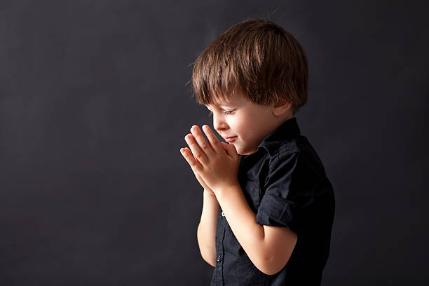 istock Little boy praying, child praying, isolated background 514312590