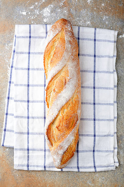 istock One fresh crunchy Baguette on slate 514313798